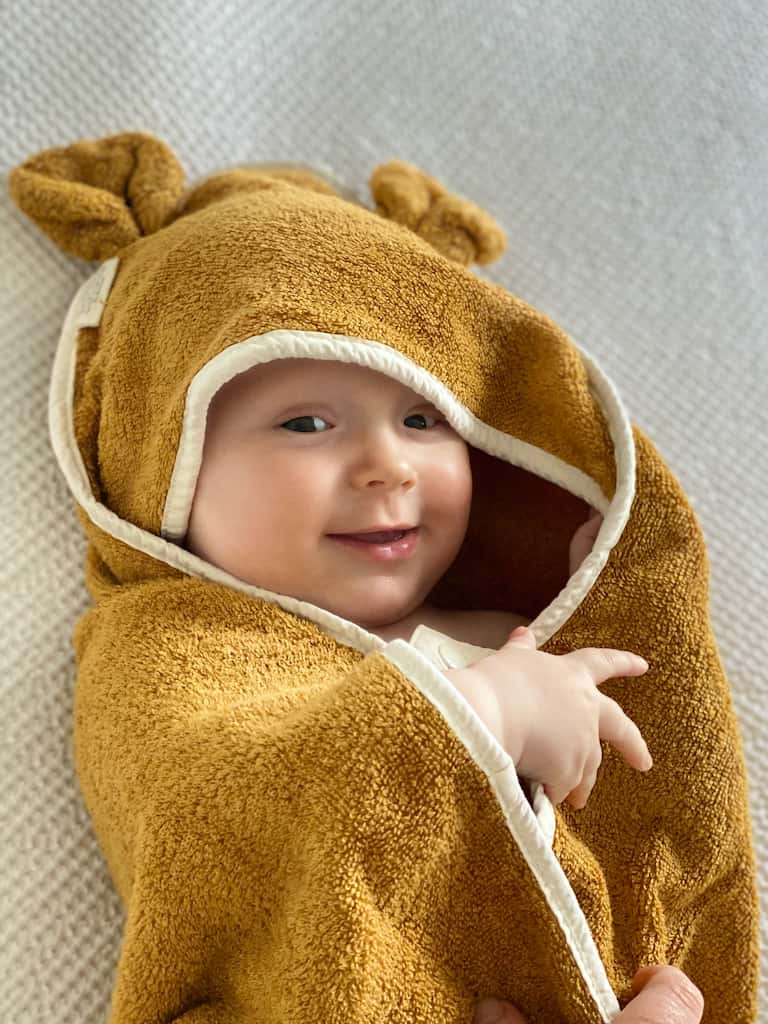 Baby wrapped in Fabelab baby hooded bath towel