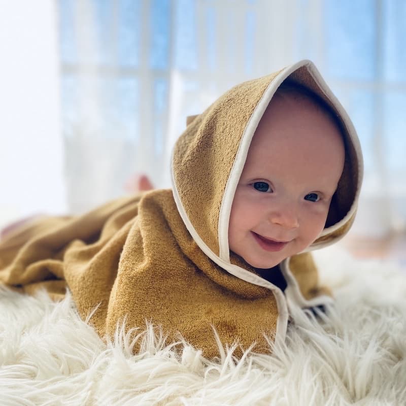 Baby wrapped in Fabelab Hooded Baby Towel Bear 