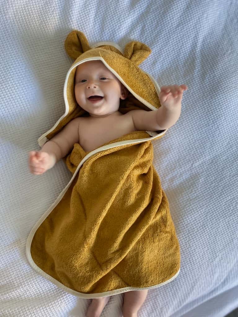 Baby wrapped in Fabelab Hooded Baby Towel Bear
