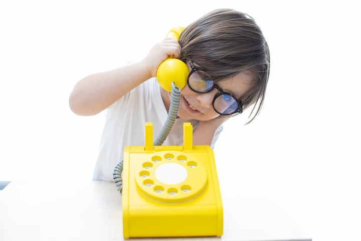 Boy playing with the Kiko+ & GG* Yellow Retro Toy Telephone 