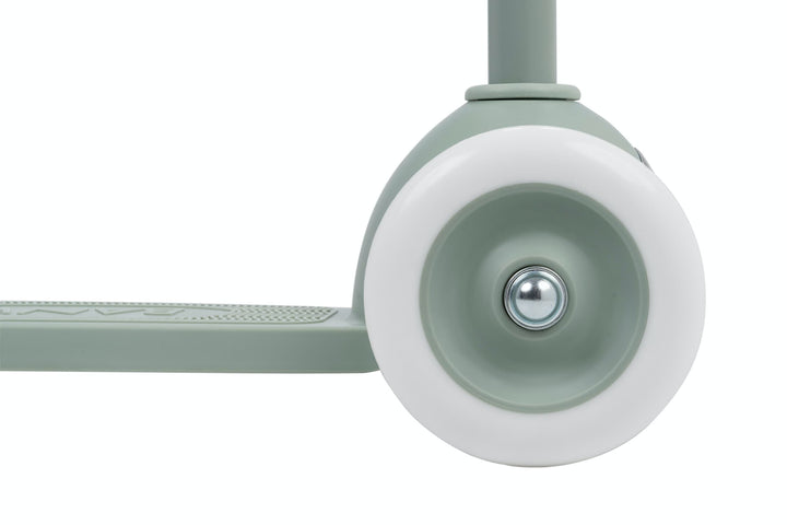 Close-up of a scooter wheel with white rim on a white background