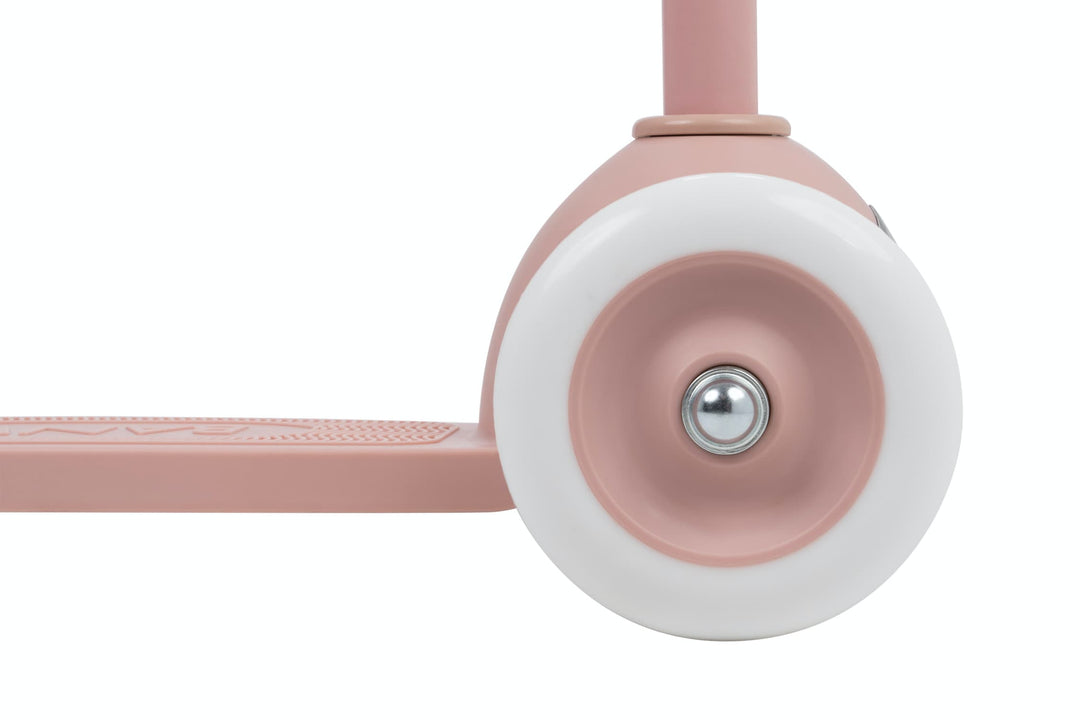 Close-up of a dusty rose scooter with a white wheel on a white background