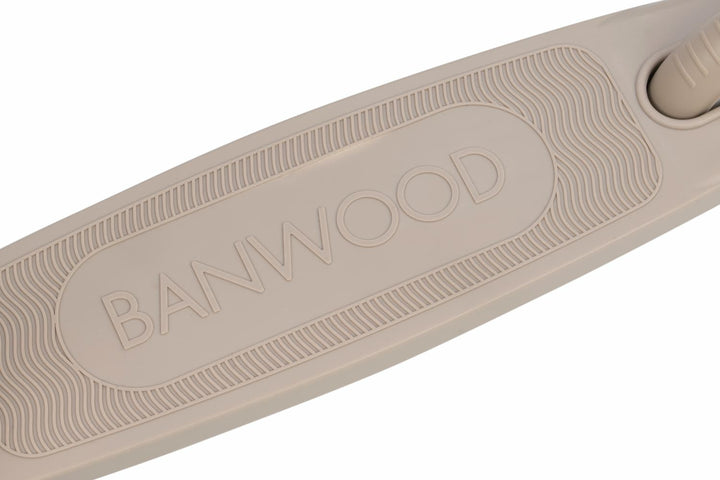 Close-up of a beige scooter deck with 'Banwood' branding on a white background