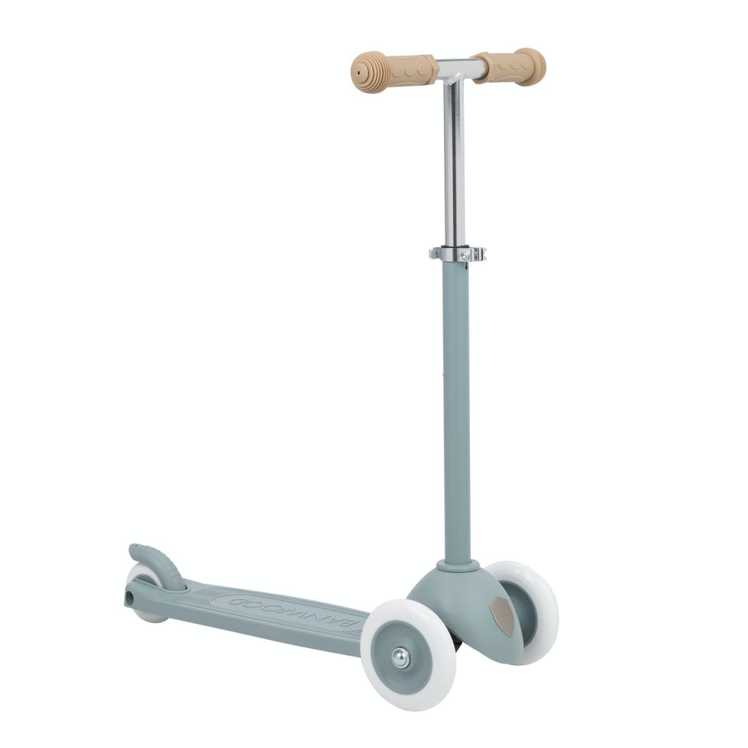 Children's scooter with teal body and beige rubber grips on handlebar on a white background