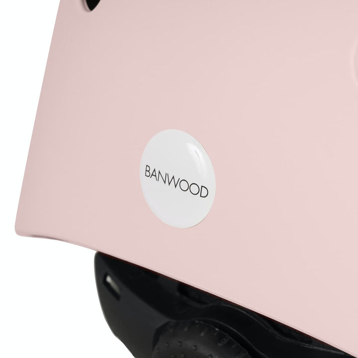 Close-up of a pink helmet with a 'Banwood' logo on a white background