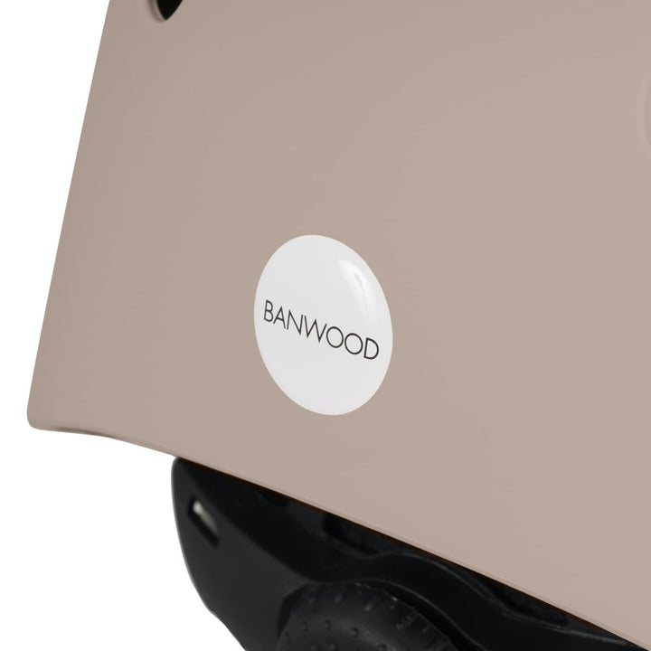 Close-up of a sand colour helmet with a white 'BANWOOD' label on a white background