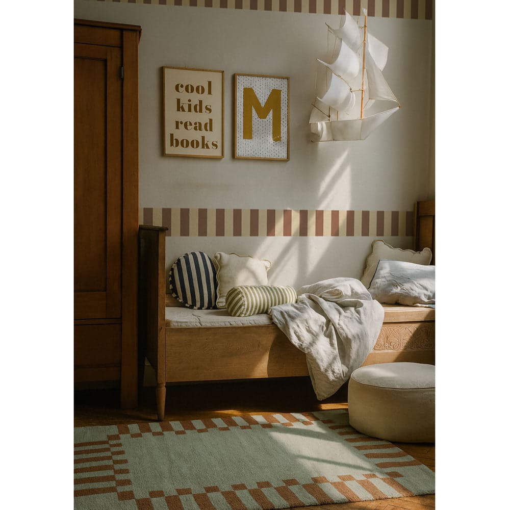 Nursery room with wooden bench, striped rug, and decorative wall art.