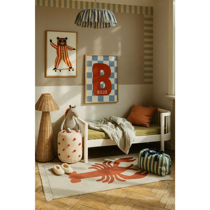 Children's room with a bed, lamp, and decorative items.