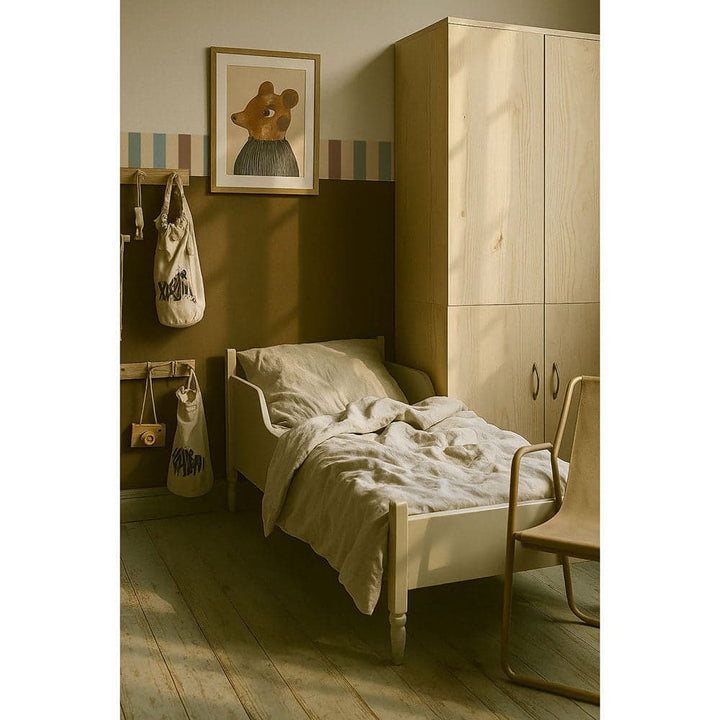 Children's bedroom with wooden wardrobe, bed, and chair.