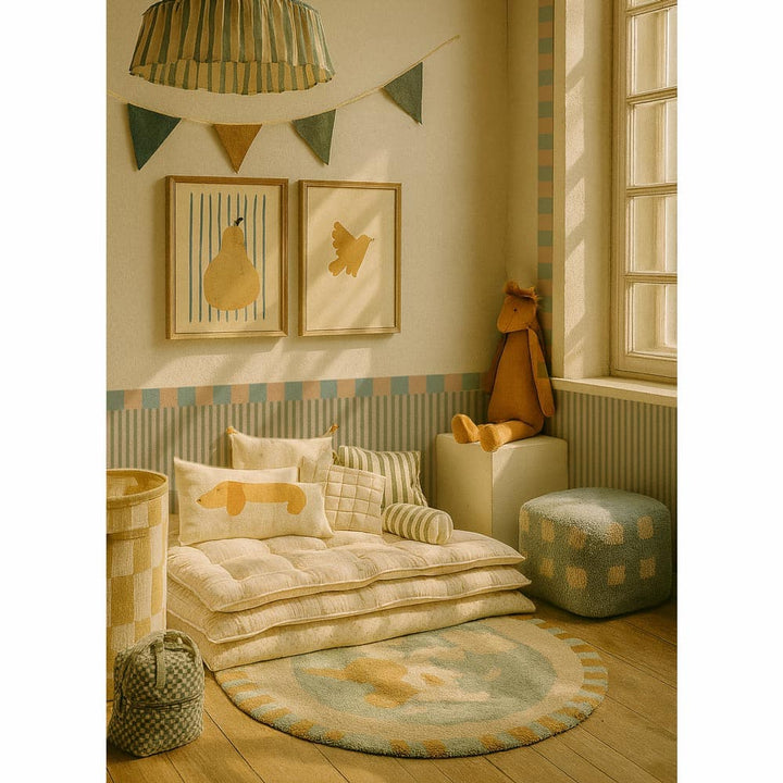 Children's room with a cozy setup featuring a sofa, cushions, and toys.