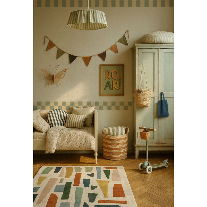 Children's room with a sofa, rug, and decorative elements.