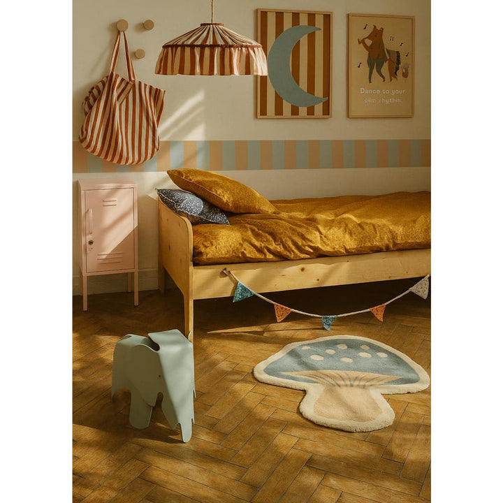 Children's bedroom with wooden bed, colorful rug, and decorative elements.