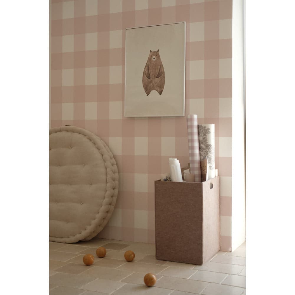 Children's room with pink checkered wall, round cushion, and toy box.