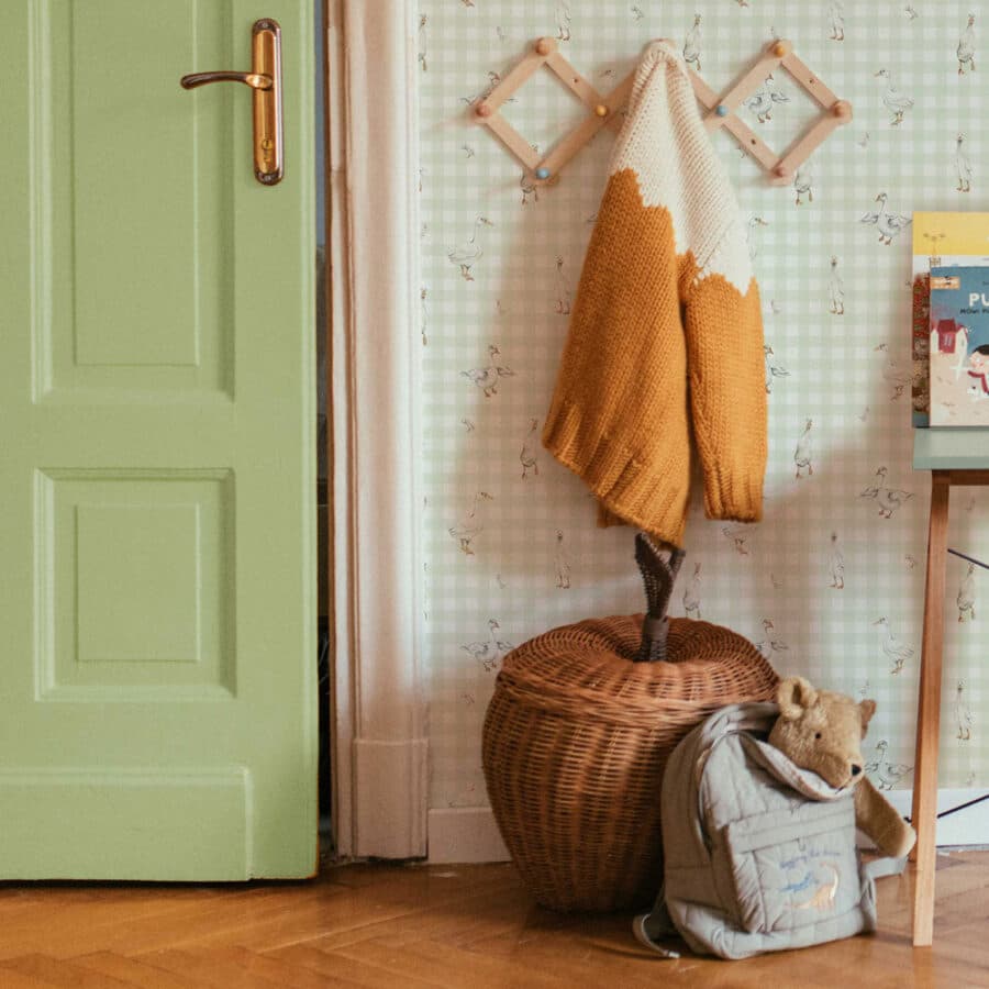 Room interior with a green door, wicker basket, and decorative items.
