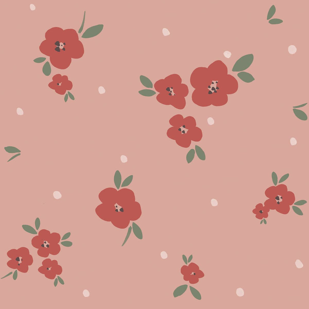 Pattern of red flowers with green leaves on a pink background with white dots.