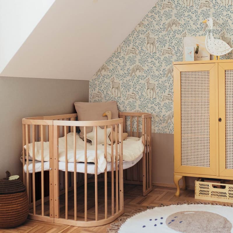 Dekornik Forest Animals & Fairytale Beige Wallpaper on a feature wall behind nursery crib