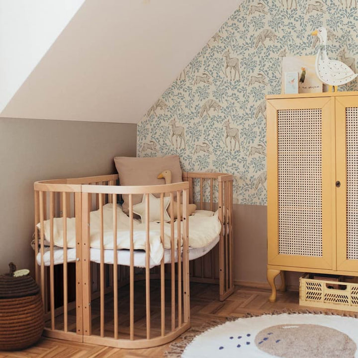 Dekornik Forest Animals & Fairytale Beige Wallpaper on a feature wall behind nursery crib