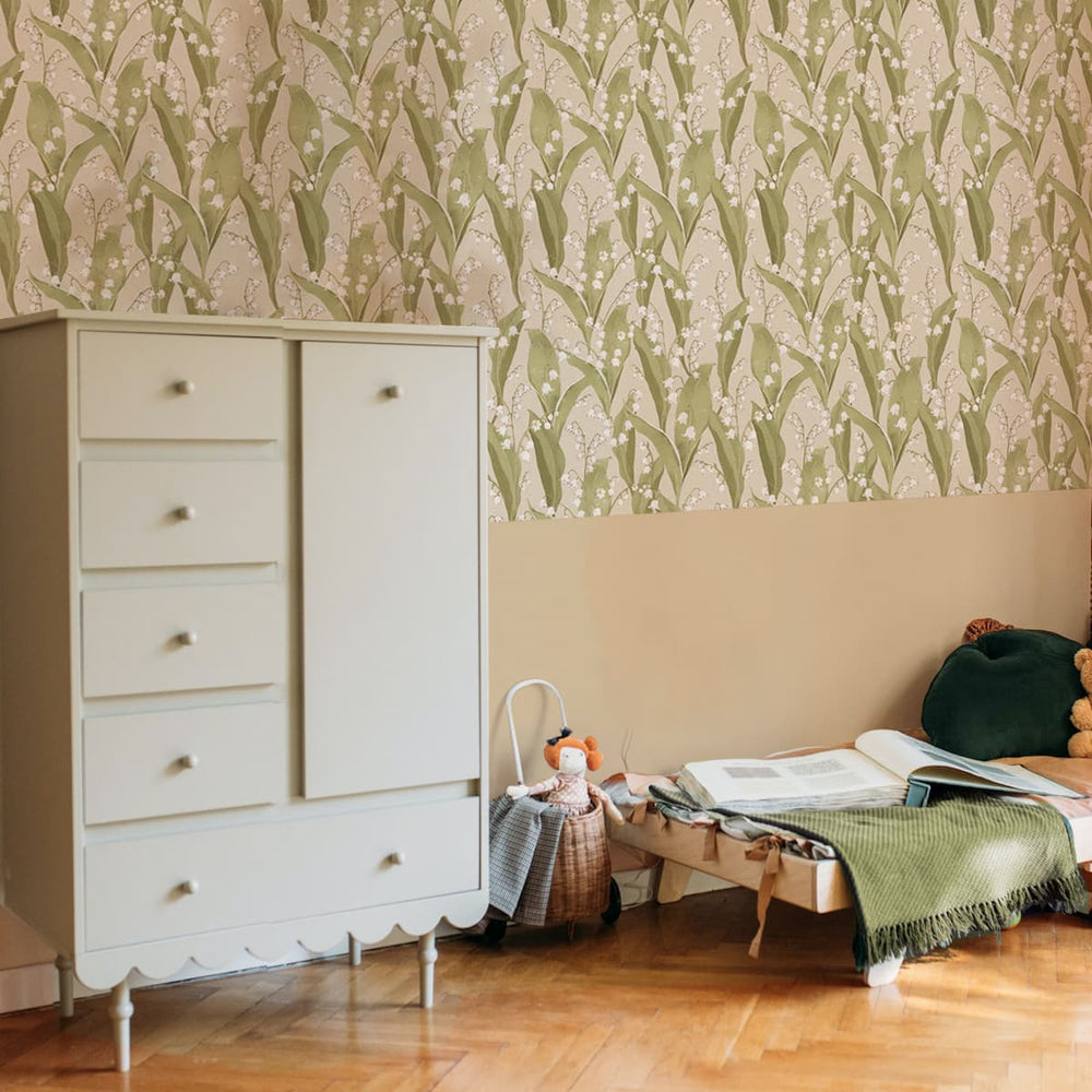 Children's room with white dresser, patterned wallpaper, and toys on a bed.