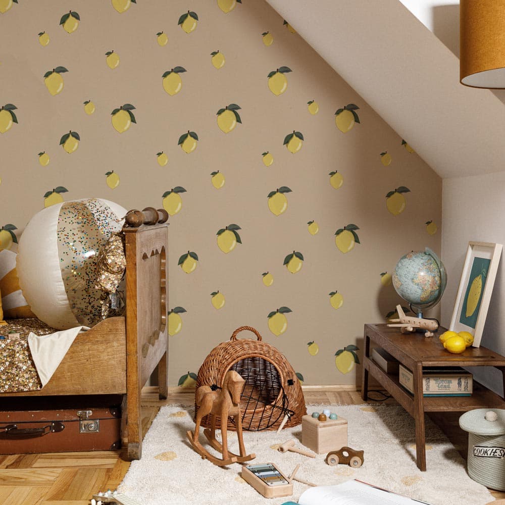 Children's room with lemon-patterned wallpaper, wooden furniture, and toys.
