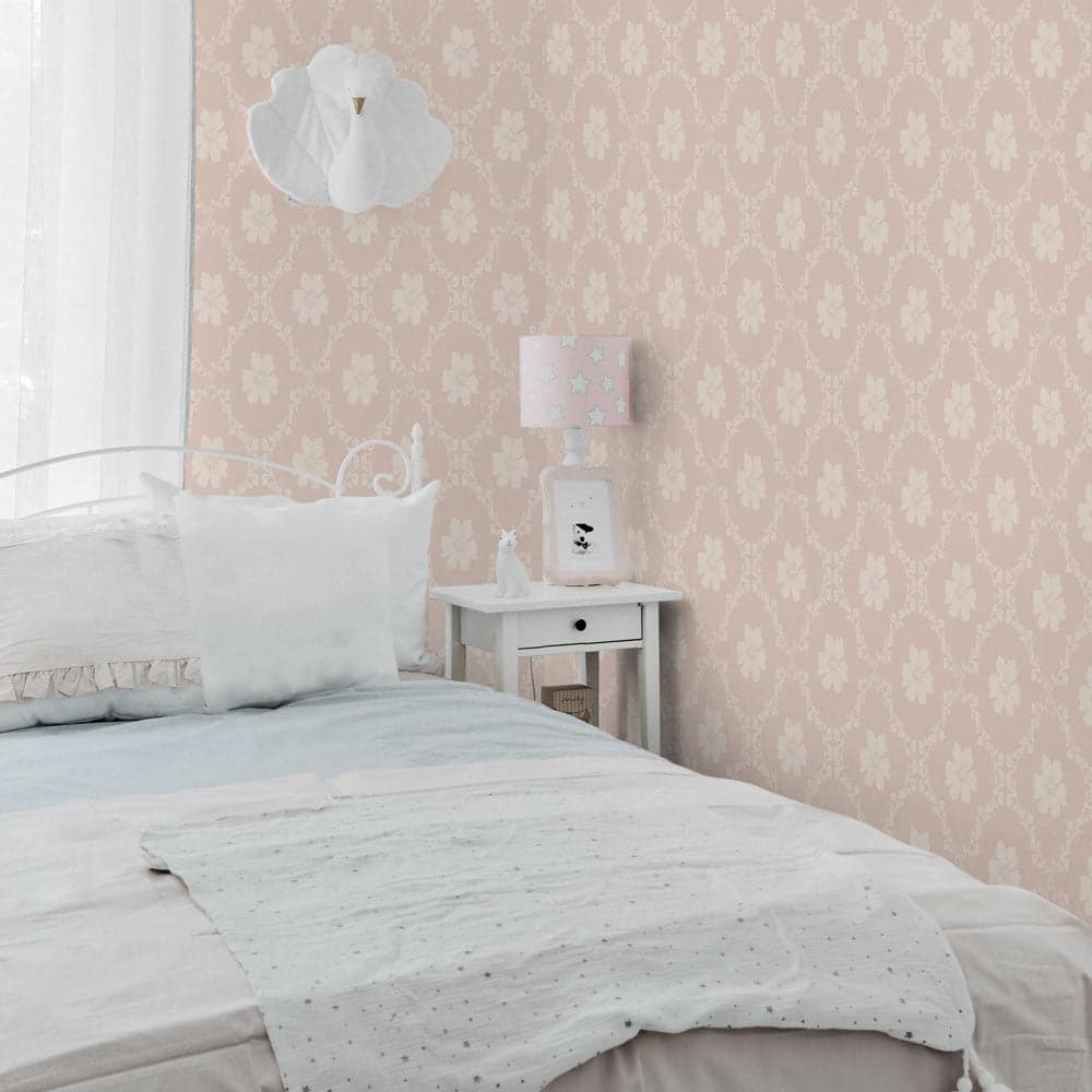 Bedroom with floral wallpaper, bed, and nightstand with lamp.