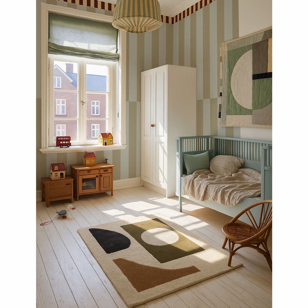 Children's room with striped wallpaper, wooden furniture, and a rug with abstract design.