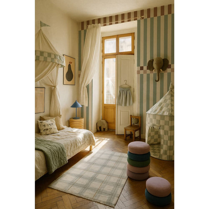 Children's bedroom with checkered bed, striped walls, and colorful stools.