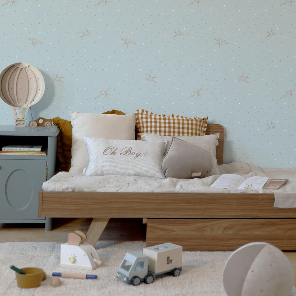 Children's bedroom with wooden bed, toys, and decorative elements.