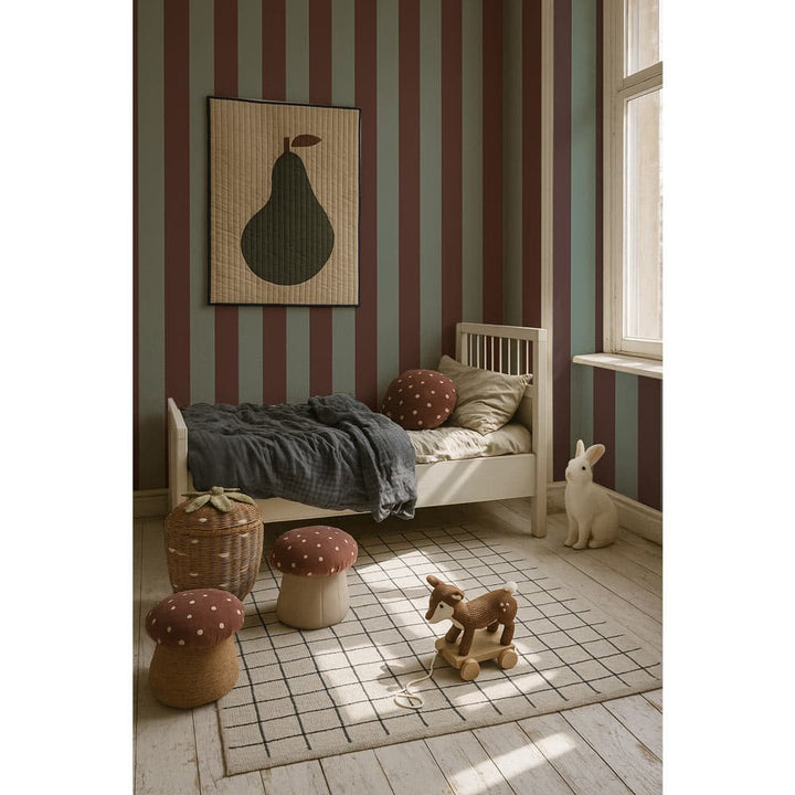Children's room with striped walls, wooden bed, and toys on a checkered floor.