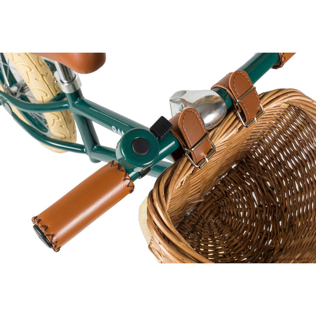 Top view of the Green Banwood First Go Balance Bike wicker basket and bell