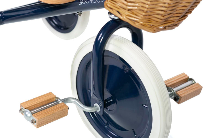 Close up of the navy Banwood Trike pedals and front wheel
