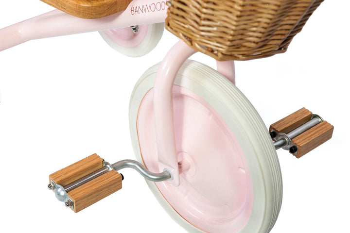 Close up of the pink Banwood Trike pedals and front wheel