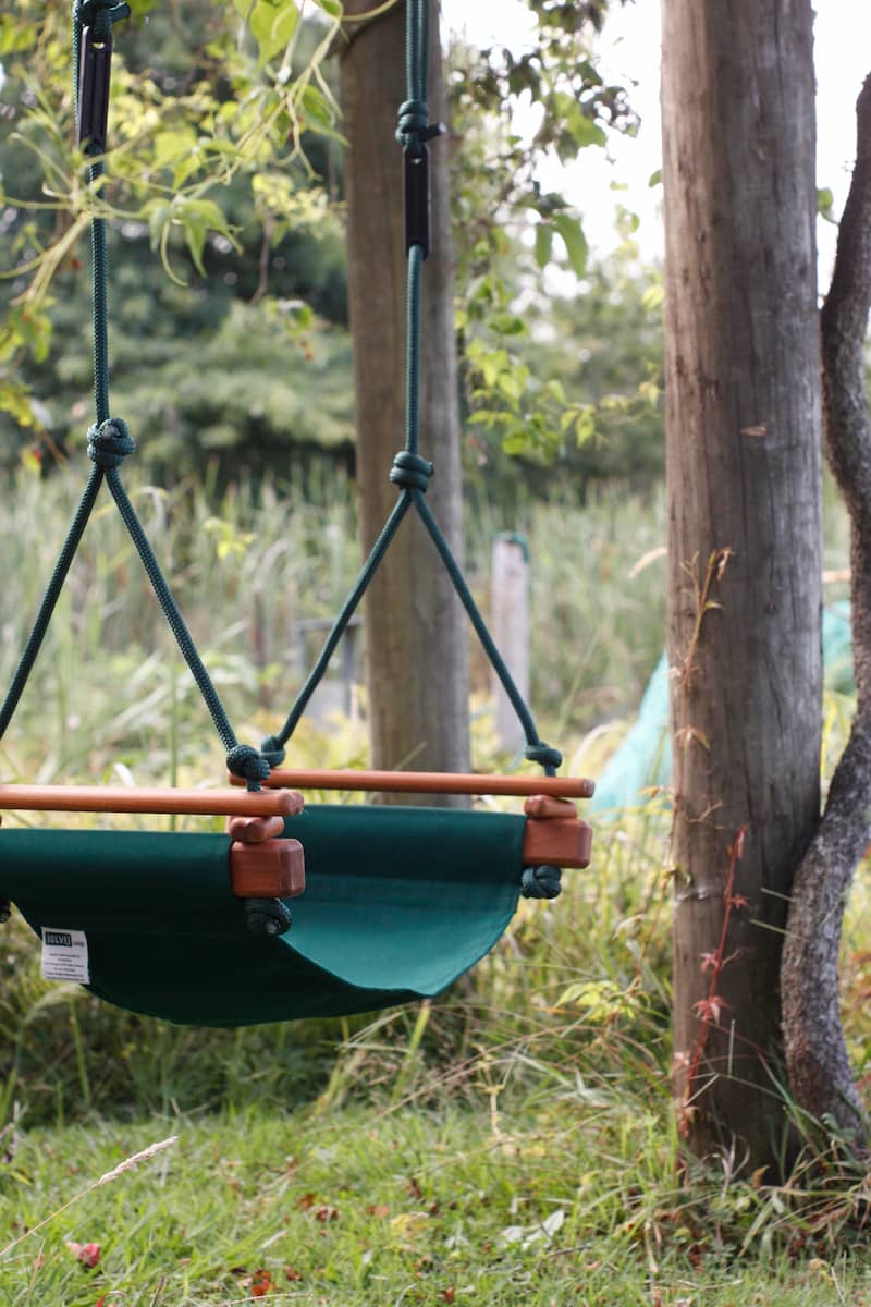 Forest Green Solvej Swings Child Swing hanging outside