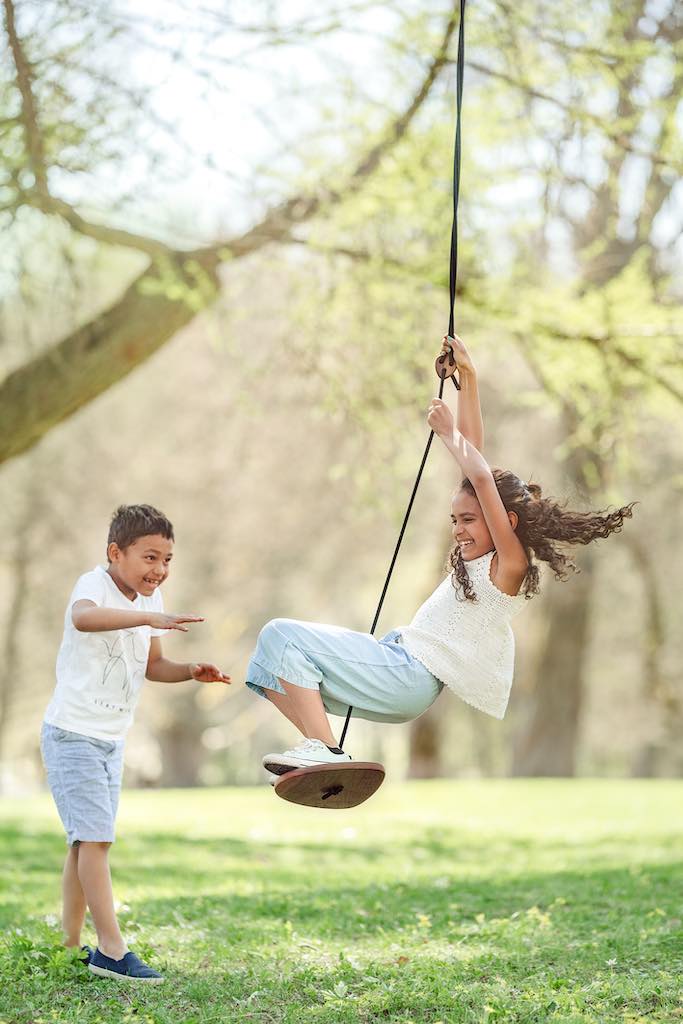 Children playing on Lillagunga Disco Swing