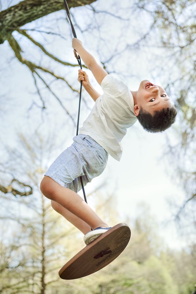 Boy playing on Lillagunga Disco Swing