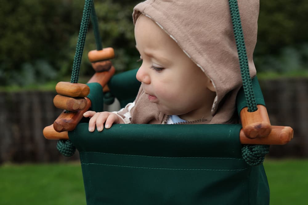 baby in forest green Solvej Swings Baby & Toddler Swing